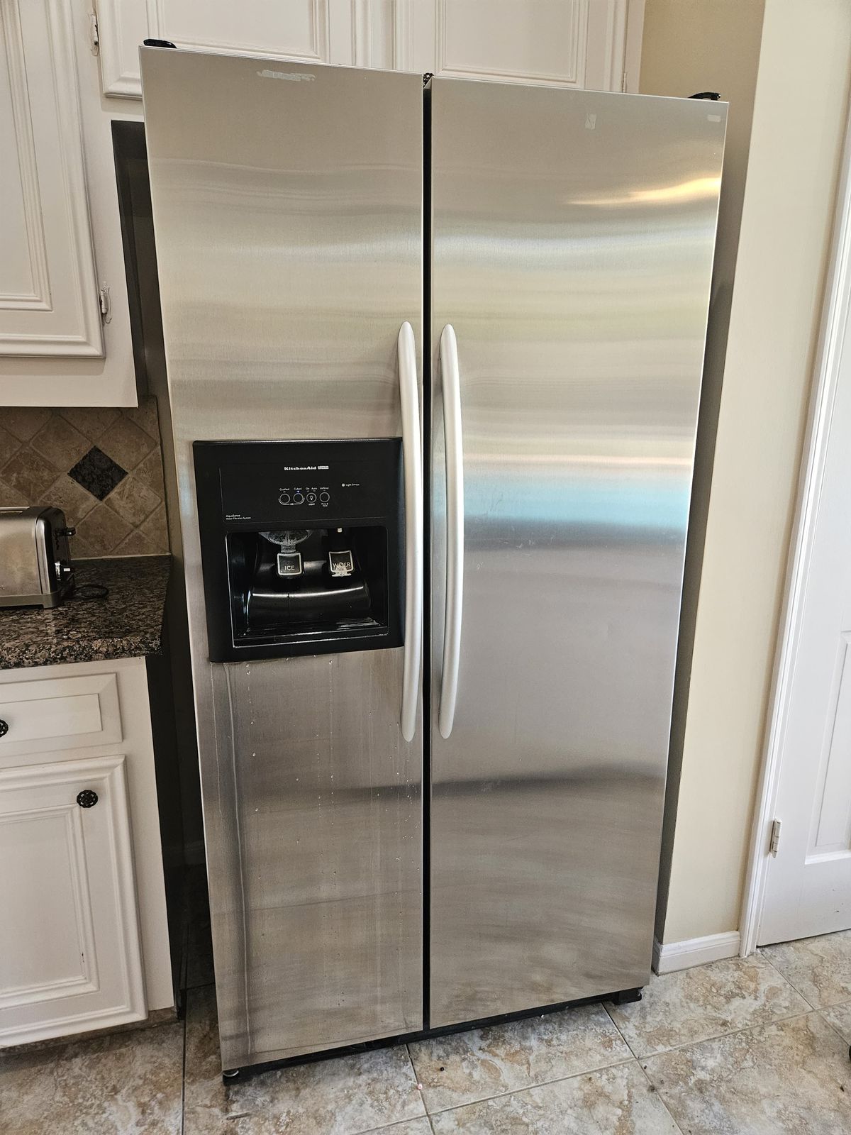 Stainless side-by-side refrigerator back in service in a kitchen