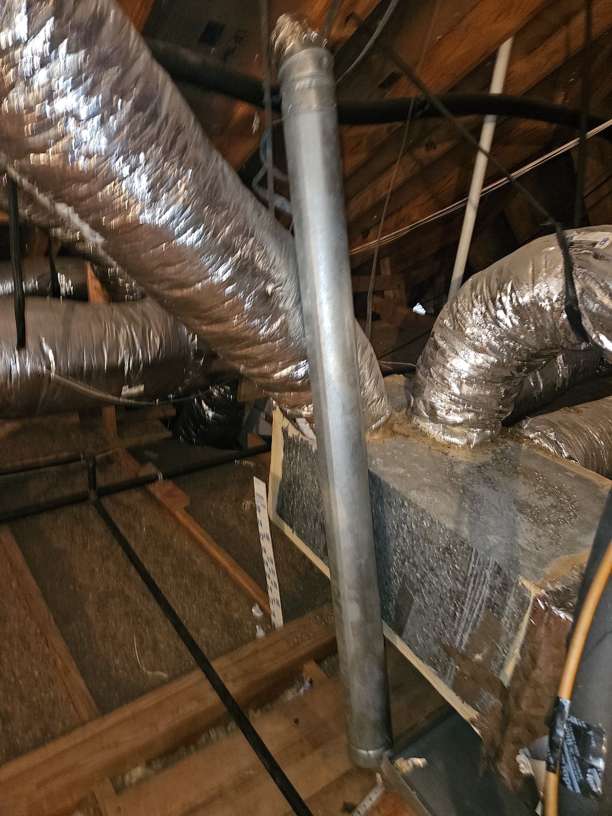 Flexible ductwork in an attic during an airflow inspection